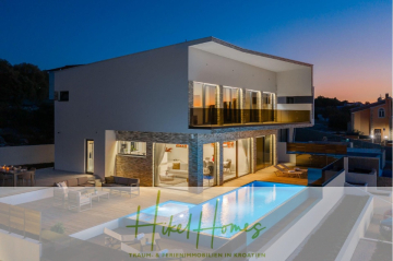 Moderne zweistöckige Villa in Kroatien mit großen Glasfenstern, einem beleuchteten Pool, Loungebereichen im Freien und Abendbeleuchtung. Das Logo "Hike Homes" und der Text "Traum- & Ferienimmobilien in Kroatien" erscheinen am unteren Rand. - Seeview 2 von 3 | Möbilierte Luxus-Meerblick Villa mit 4 SZ, Pool, Sauna, Fitness, Jacuzzi,
