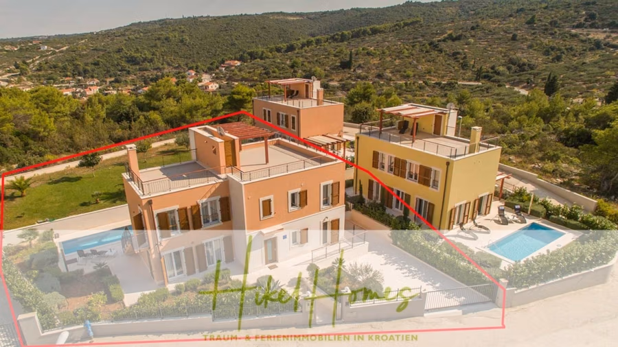 Villa im Mittelmeerstil mit 3 SZ, Pool, Dachterrasse mit Meerblick (3/4) - Luftaufnahme zweier moderner, farbenfroher Häuser mit Flachdächern an einem üppig grünen Hang. Das linke Haus ist rot hervorgehoben. Neben dem rechten Haus ist ein Swimmingpool zu sehen. Bäume und Laub umgeben das Gebiet. (43301)
