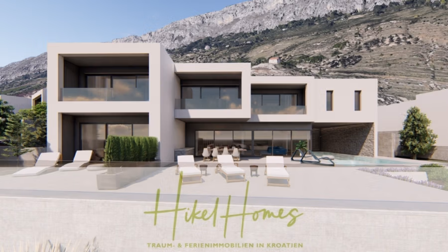 Schlüsselfertige – großzügige Meerblick Villa in ruhiger Lage, 4 SZ, 4 Bäder, Pool, Jacuzzi, … - Eine moderne, minimalistische Villa mit großen Fenstern und Balkonen vor einer Bergkulisse. Im Vordergrund befindet sich eine Terrasse mit Sonnenliegen und einem kleinen Pool. Unten ist der Schriftzug „Hikel Homes“ zu sehen. (41015)