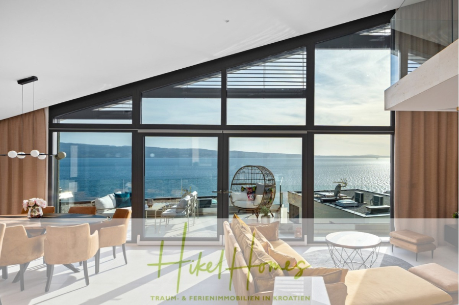 Direkt einziehen Meerblick Villa NATALIA mit Infinity Pool, 3 SZ, Sommerküche, … - Geräumiges, modernes Wohnzimmer mit hoher Dachschräge und großen Fenstern mit Blick auf den Balkon und das Meer. Neutrale Möbel, sichtbarer Essbereich und Hängesessel; helle, luftige Atmosphäre. (43875)